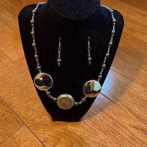 Beaded string necklace with black pearl accents and silver pendants